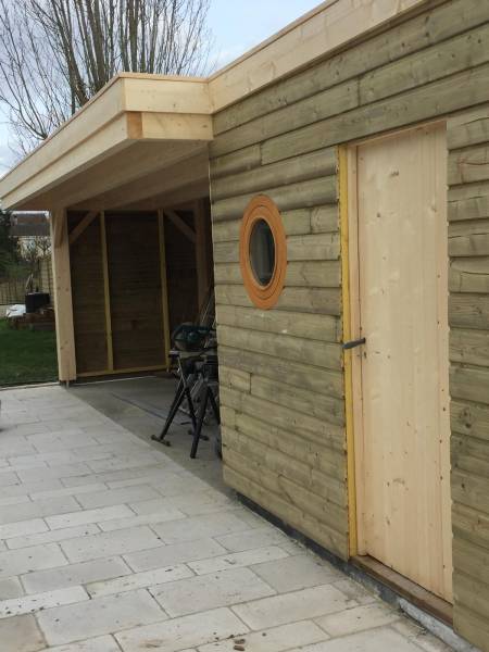 Réalisation d’un pool house avec local technique, assise intégrée et hublot en bardage bois à Martillac